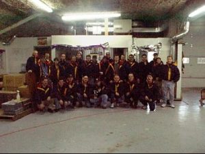 Group photo of Demers workers standing together inside an industrial workspace
