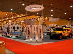 Demers trade show display featuring emergency vehicles and branded signage