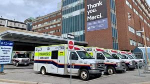 Row of Demers ambulances parked outside a hospital building