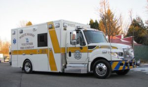 Demers ambulance parked on a roadway in a residential area.