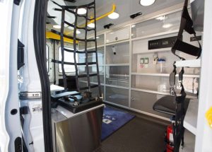 Interior of a Demers ambulance patient area with storage cabinets and seating